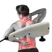 Young man suffering from body pain using body massager
